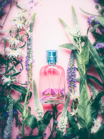 Foral Perfume bottle with plants and flowers, top view. Perfumery, cosmetics, botanical fragrance concept.の写真素材