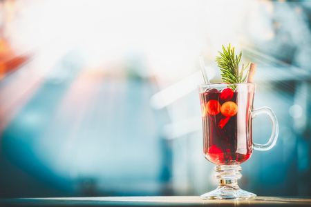 Christmas with glass of mulled wine at winter day background, front viewの写真素材