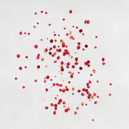 Red peppercorns on white stone background, top viewの写真素材