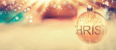 Christmas background with glass decorating  ball and text Christmas at blurred room and bokeh lighting, bannerの写真素材
