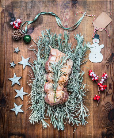 Christmas roast preparation on wooden background with festive decoration, top viewの写真素材