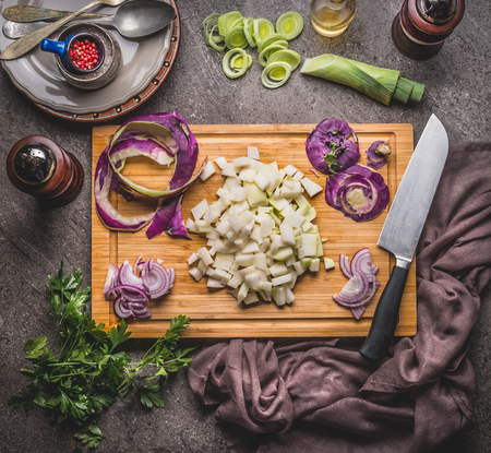 Cooking preparation with vegetables: kohlrabi and leeks on wooden cutting board with knife on rustic background, top view. Healthy vegetarian food and eating, clean or diet nutrition conceptの写真素材