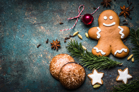 Christmas background with festive decoration, cookies, gingerbread man and fir branches top view,...