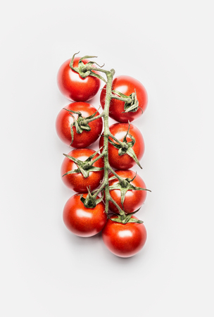 Red cherry tomatoes bunch on white background, top viewの写真素材