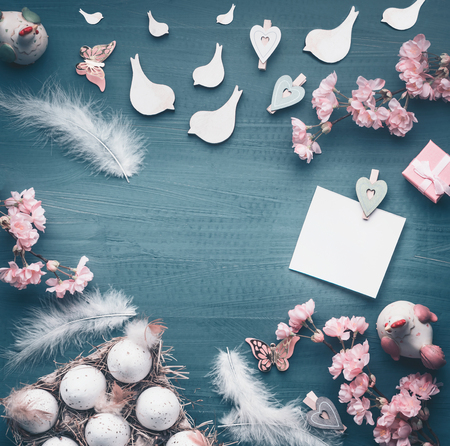 Easter background frame with eggs in crate box , decorative spring blossom, greeting card mock up ,  pastel styledの写真素材