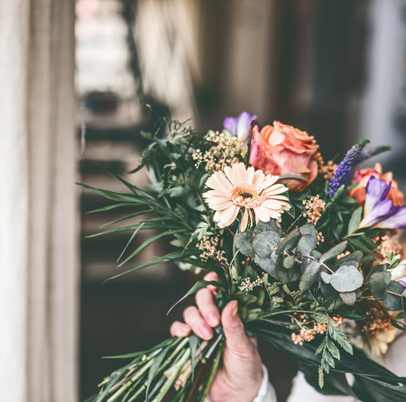 Beautiful flowers bunch in female handの写真素材