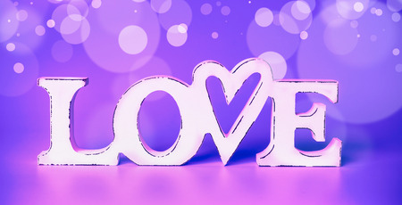 White word love at neon color bokehの写真素材
