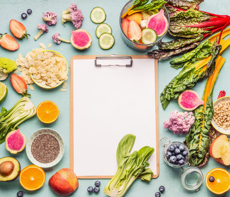 Healthy smoothie ingredients around  clipboard with blank paper sheet on light table, top view, frame.の写真素材