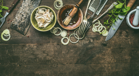 Kitchen utensils on rustic wooden background with fresh seasoning, BBQ simple marinade, top view. Copy space.の写真素材