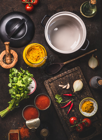 Healthy fresh ingredients for tomato soup on dark rustic kitchen table background, top viewの写真素材