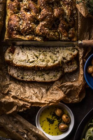 Close up of fresh baked homemade focaccia bread  with olives oil, top view. Traditional italian...