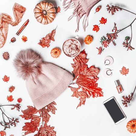 Autumn concept with knit hat with pom pom, woolen scarf, pumpkin.の写真素材