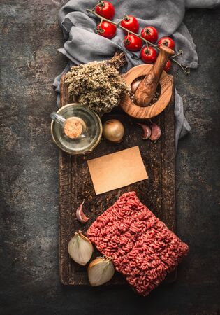 Minced meat und cooking ingredients for Bolognese sauce on dark rustic kitchen table, top viewの写真素材