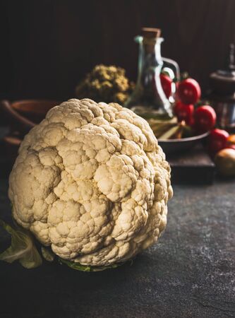 Close up of whole cauliflower on dark rustic kitchen table background. Copy spaceの写真素材