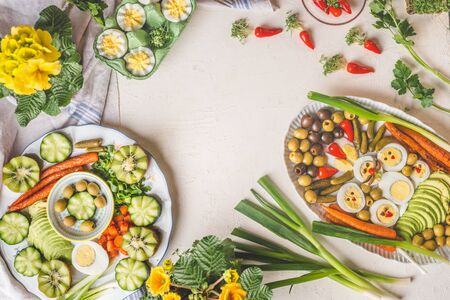 Traditional Easter food background with tasty egg plates. Funny Bunny rabbit and chicken made with...