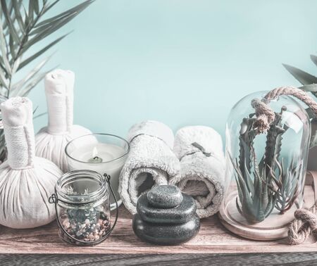 Spa equipment with herbal compressing ball, zen hot stones and towels.