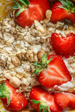Close up of oat granola with nuts and strawberries, top viewの写真素材