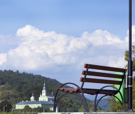 the bench stands on the background of the mountainsの写真素材