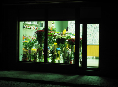 showcase of a flower shop at nightの写真素材
