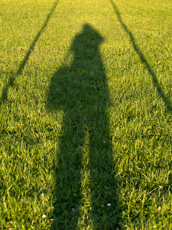 shadow of the photographer on the grass