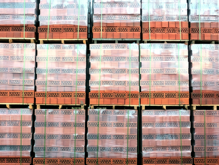 a lot of red brick pallet on the street warehouseの写真素材