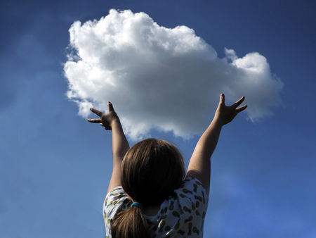child against the sky and a small cloud