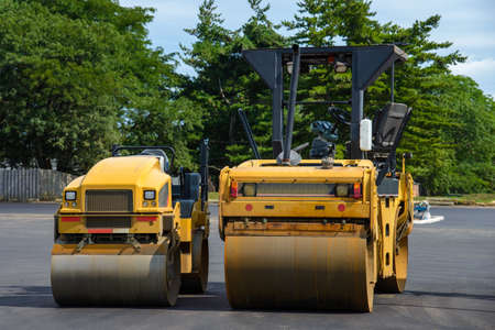 Road rollers paving a road asphalt machine yelowの写真素材