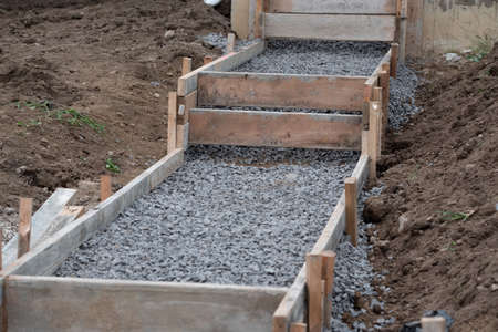 construction contractor installing a sidewalk, curb on a new urban road street project outdoor