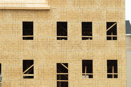 Construction of a new apartment building with the walls framed and covered with plywood fasadeの写真素材