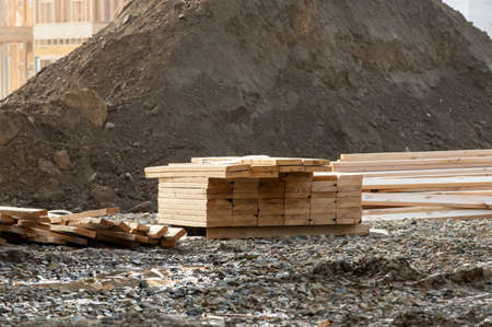 Stack of wooden planks outside house material materialの写真素材