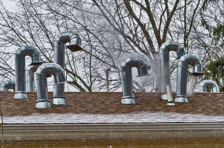 Many chimneys roof pipe house metal outdoorの写真素材