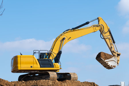 yellow excavator at construction site hydraulic work scoop