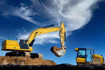 excavator digging against the blue sky hydraulic power large shovel scoopの写真素材