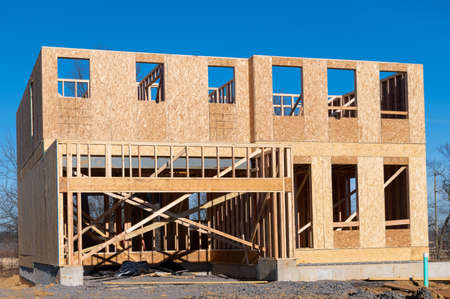 construction of a plywood new house against the blue sky frame timber plank wall