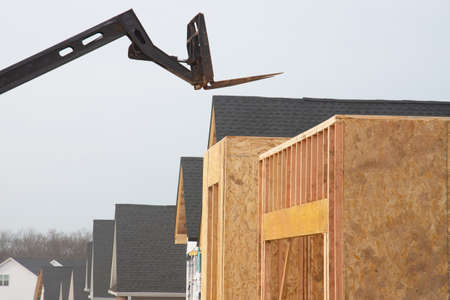 forklift at a construction site of a plywood house wood new frame industrial