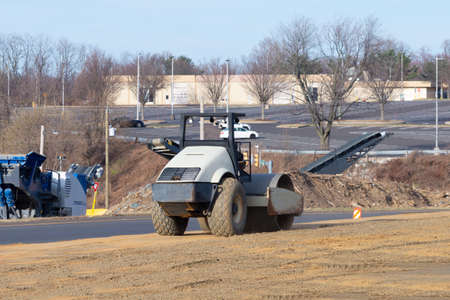 vibratory soil compactor working on highway construction site heavy roller