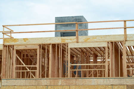 wooden frame of a new building under construction lumber fasade workの写真素材