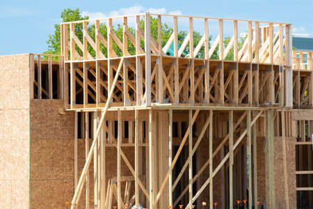 construction of a plywood house against the blue sky framing wall build studs framework