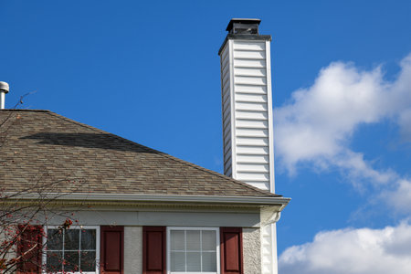 chimney from the fireplace outside house day rooftop modern sky tall blueの写真素材