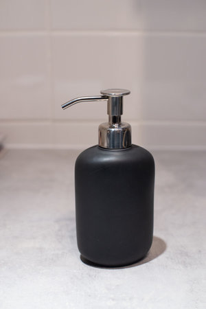 black cosmetic bottles isolated on white soap gel shampoo pumpの写真素材