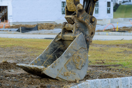 close up of excavator dirty bucket teeth digging machinery parts heavy shovel scoop largeの写真素材