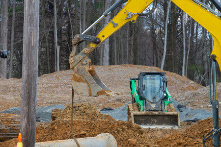 excavator digging a deep trench loader scoop mover dirtの写真素材