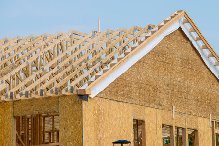 rafters and walls of a plywood house building site wooden framing unfinishedの写真素材