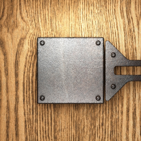 metal on wood backgroundの写真素材