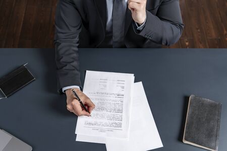 A man signing contract at the office. The concept of entering into partnership.