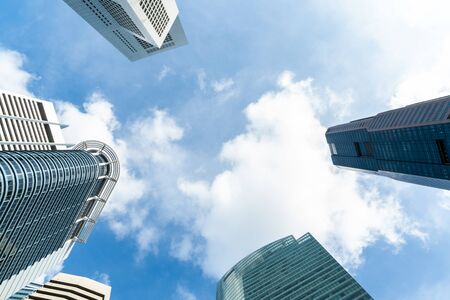 Low-angle view of picturesque skyscrapers of Singapore city downtown at day time. Financial district and trading center hub in Asia region. Concept of success. Modern buildings in high-tech world.の写真素材