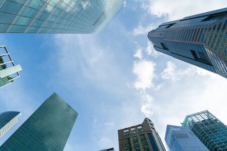 Low-angle view of picturesque skyscrapers of Singapore city downtown at day time. Financial district and trading center hub in Asia region. Concept of success. Modern buildings in high-tech world.の写真素材