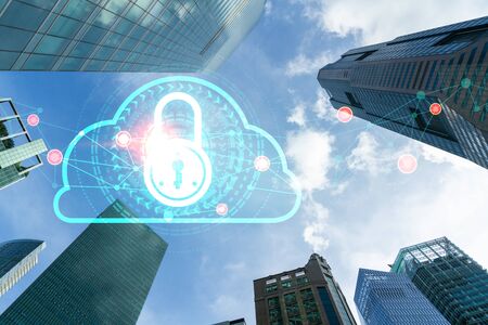Padlock icon hologram on low, wide angle view of glass and steel contemporary skyscrapers in...