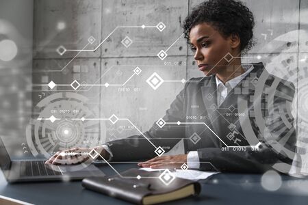Businesswoman typing on laptop work on new project. Technology drawing hologram. Double exposure. Concept of success.の写真素材