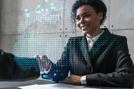 Two woman handshake. World map planet earth hologram. Multiexposure. International business.の写真素材